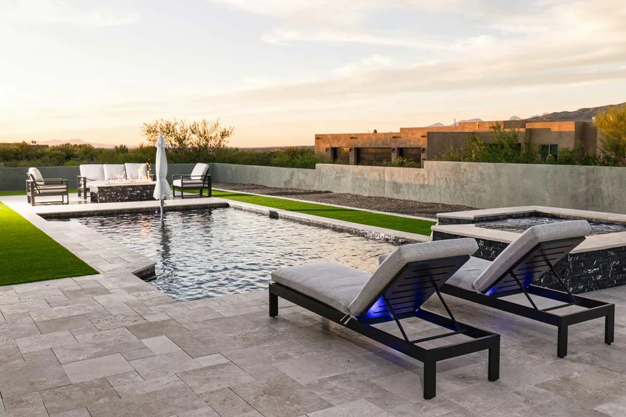 Luxury custom pool design in Tucson with integrated spa and landscape lighting